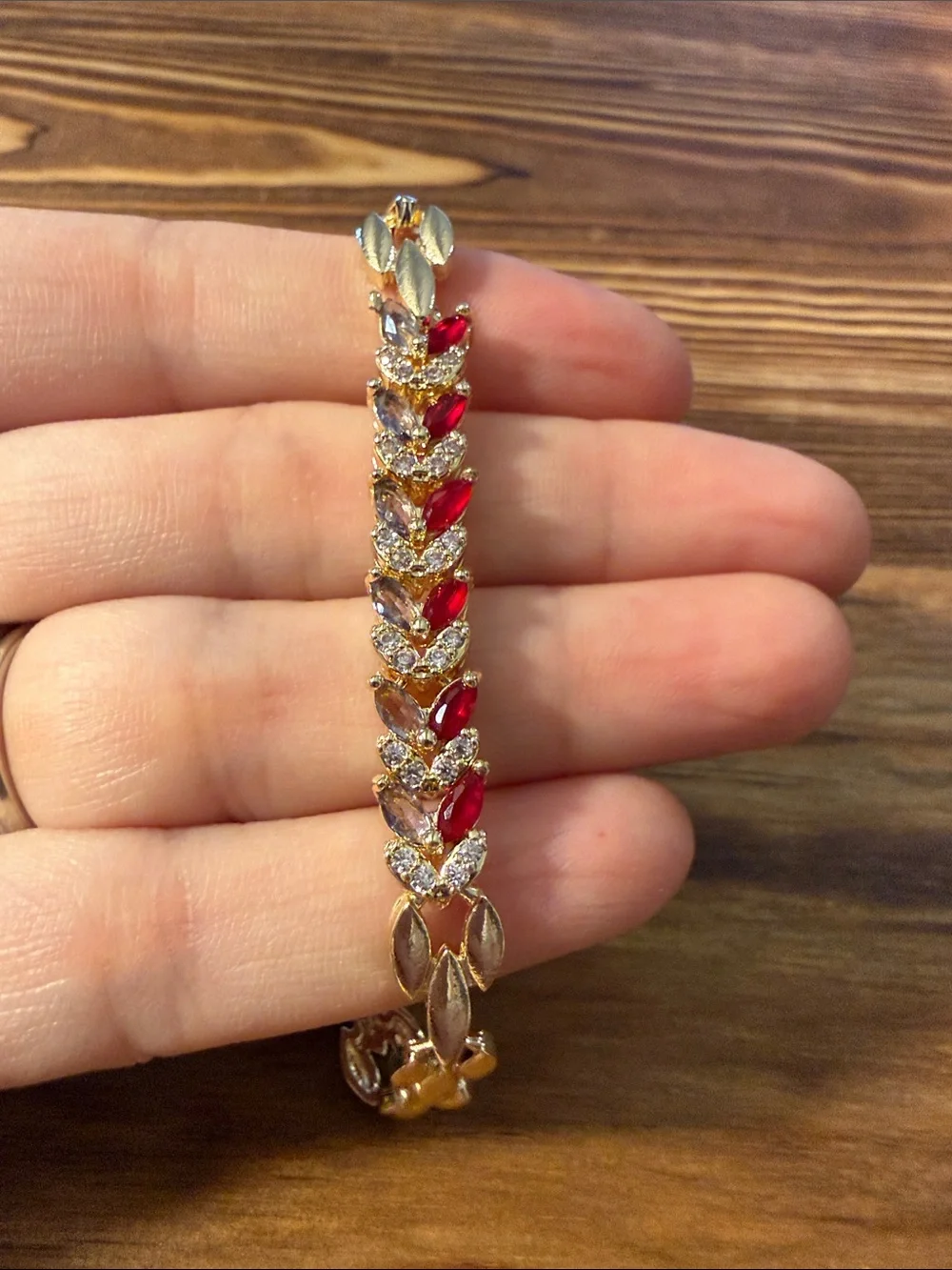 Gold-Tone Bracelet with Red Gem Leaf Accents